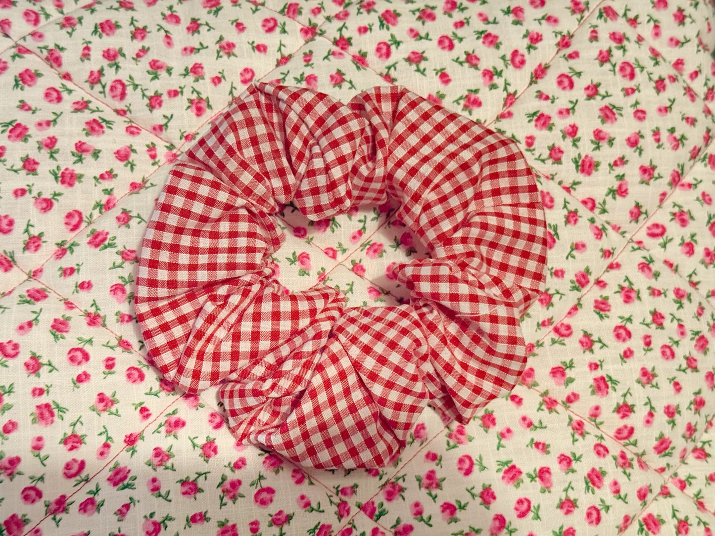 A meduim red and white gingham hair accessory scrunchie